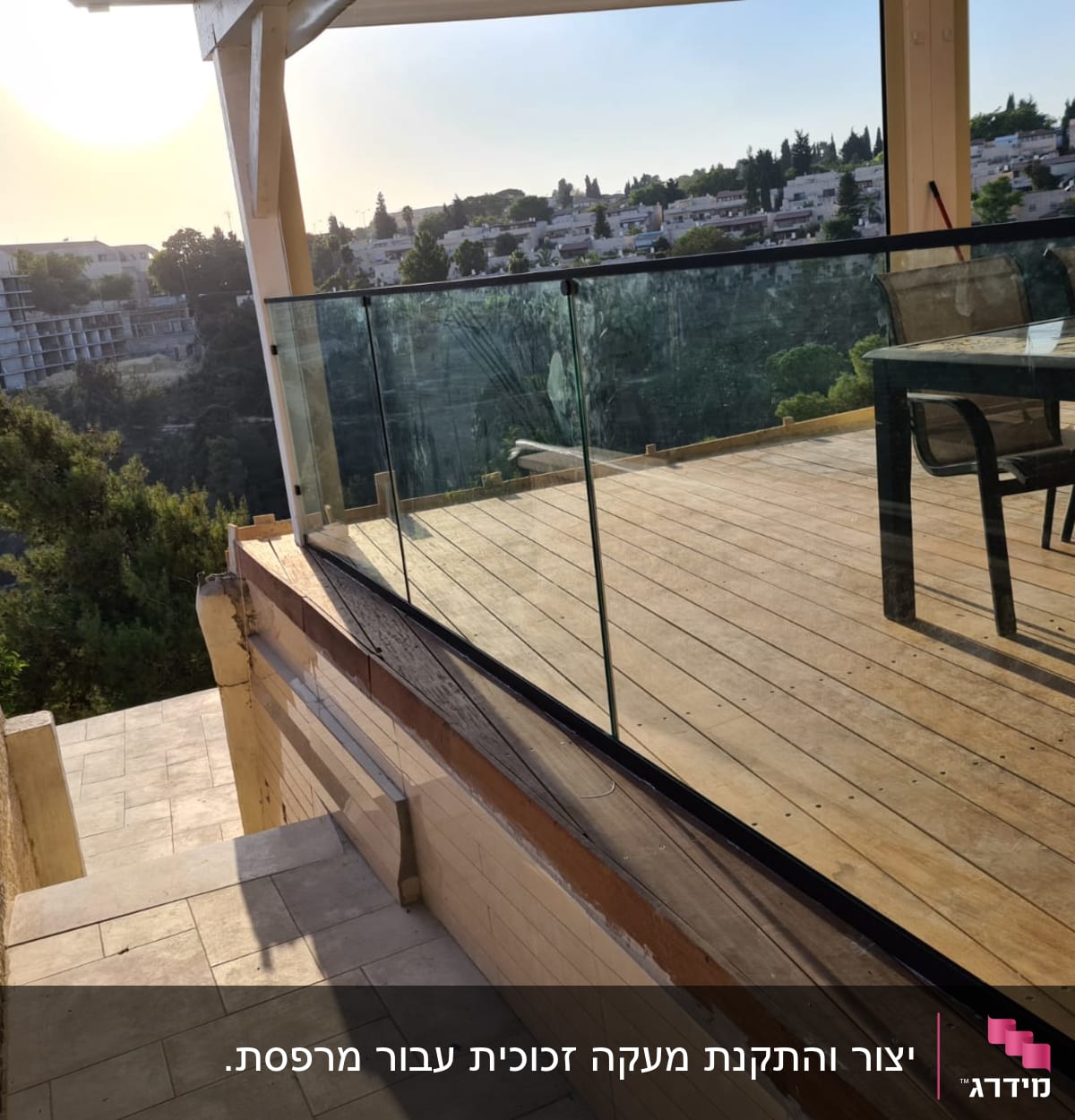 מעקה זכוכית על מרפסת עץ עם נוף עירוני